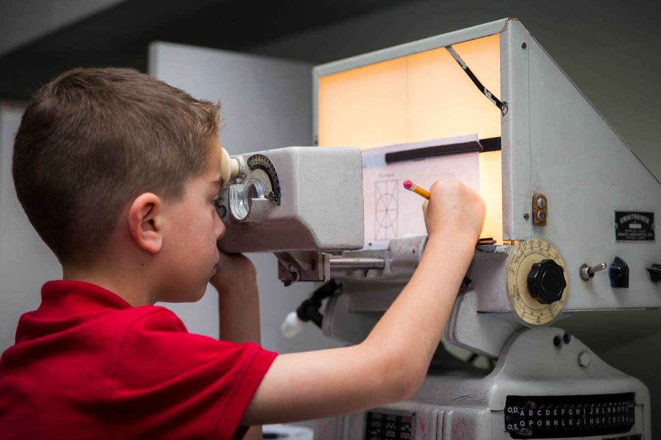 A young Walesby patient tracing at a therapy instrument that generations of patients have used
