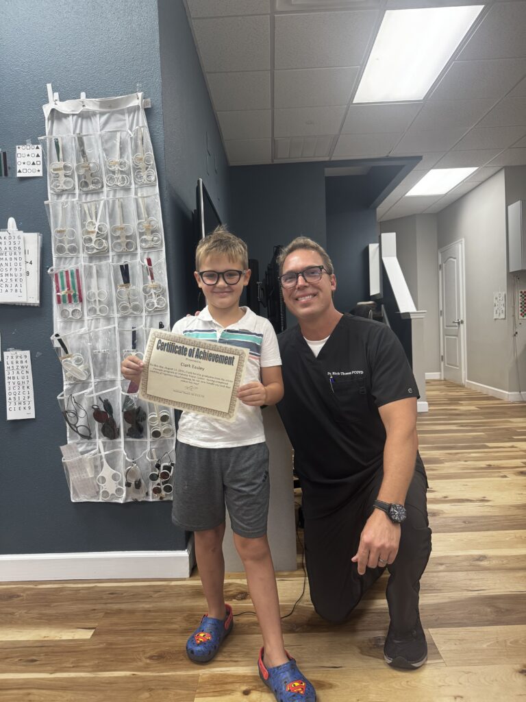 Clark celebrating his vision therapy graduation with Dr. Thomas