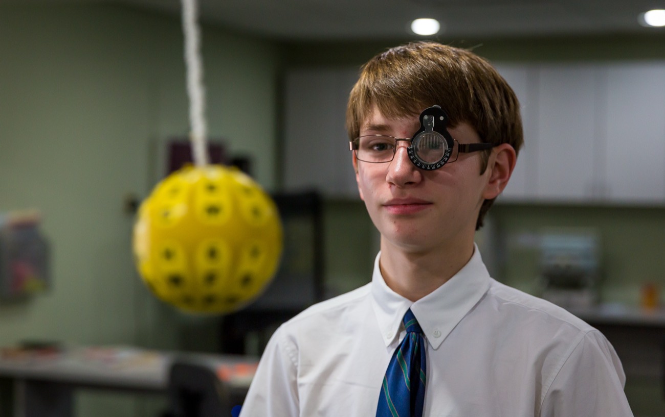 A patient wearing a trial frame during a Marsden ball tracking exercise