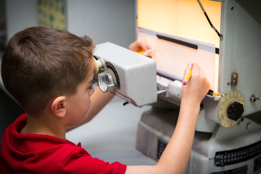 A young patient tracing at a classic therapy instrument