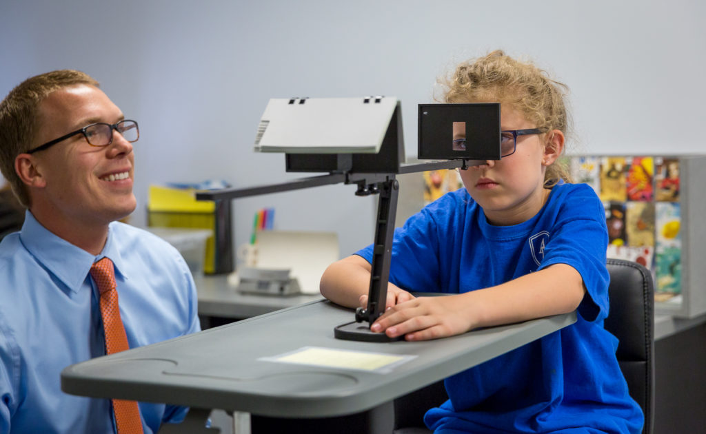 Dr. Thomas working one-on-one with a young patient in the Walesby therapy lab